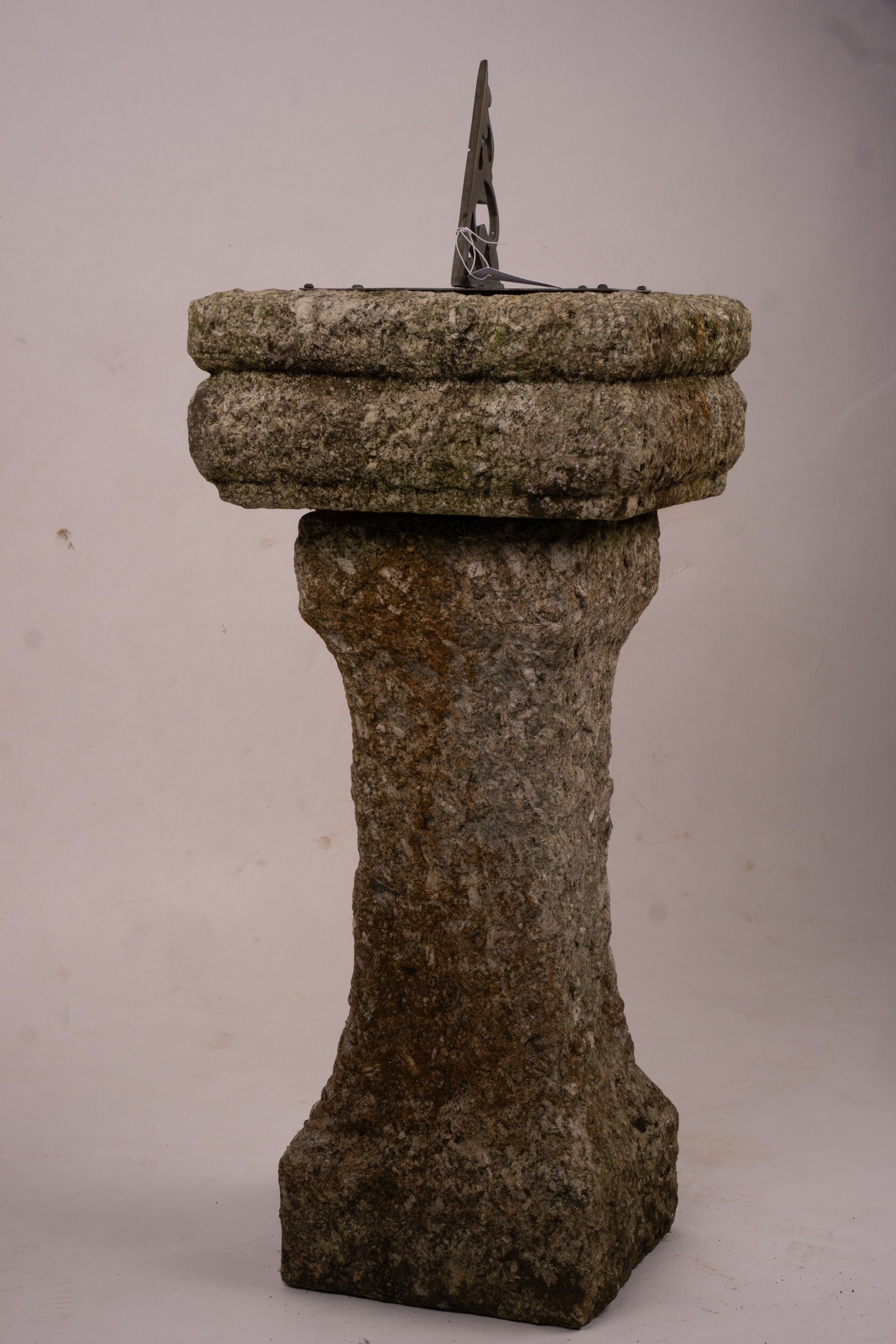 An octagonal sundial on reconstituted stone plinth, height 92cm